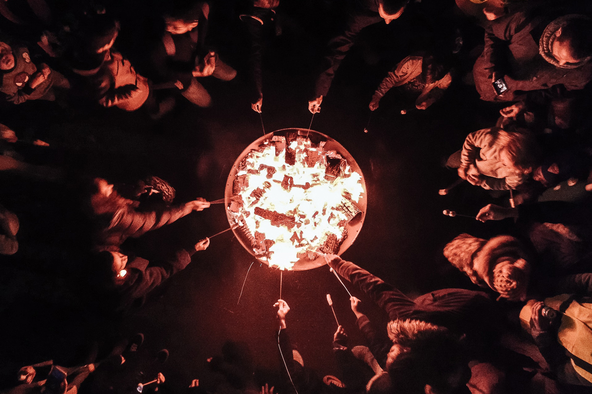 Bonfire from above with people roasting marshmallows